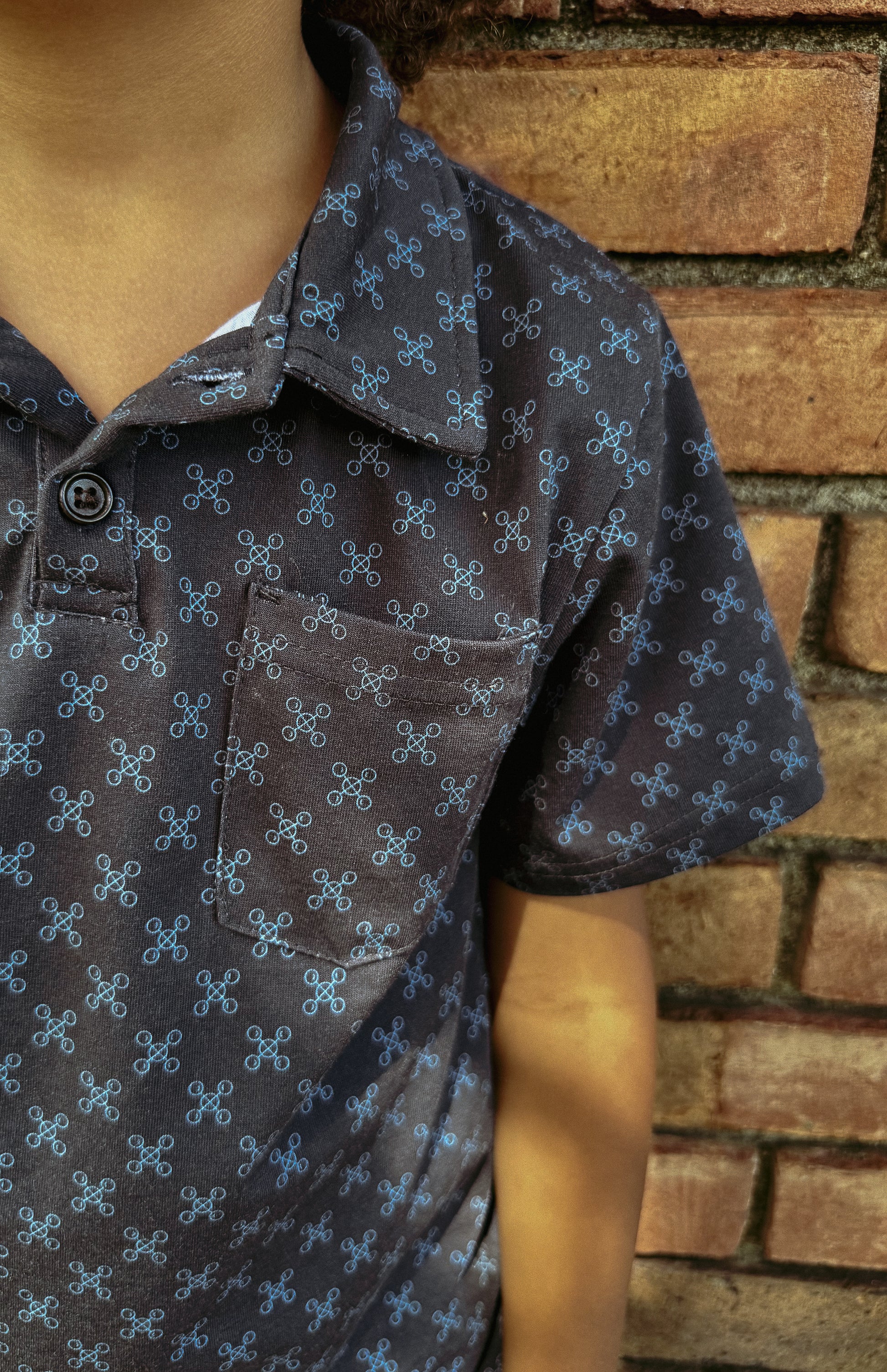 Young boy wearing a dark blue polo shirt