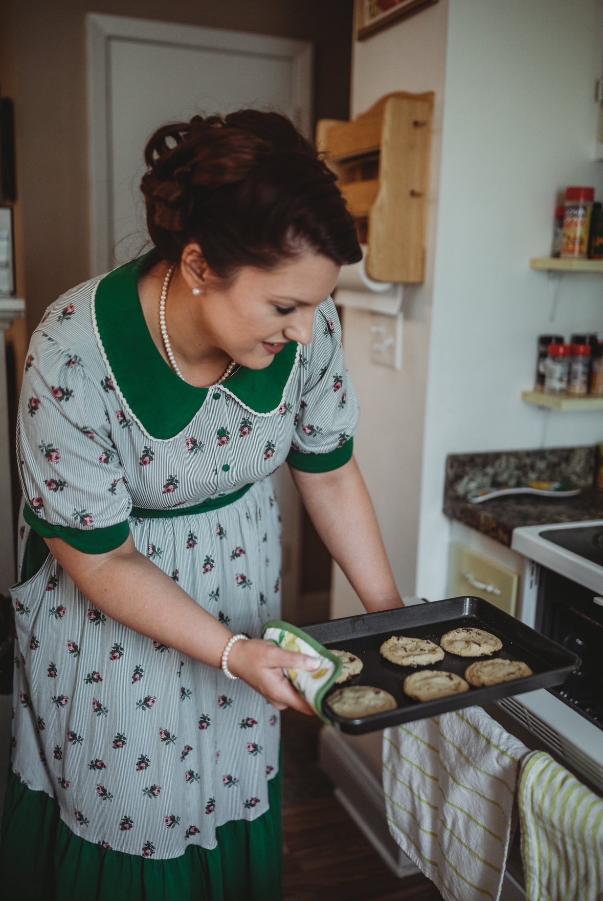 woman wearing a green and white striped modest nursing dress