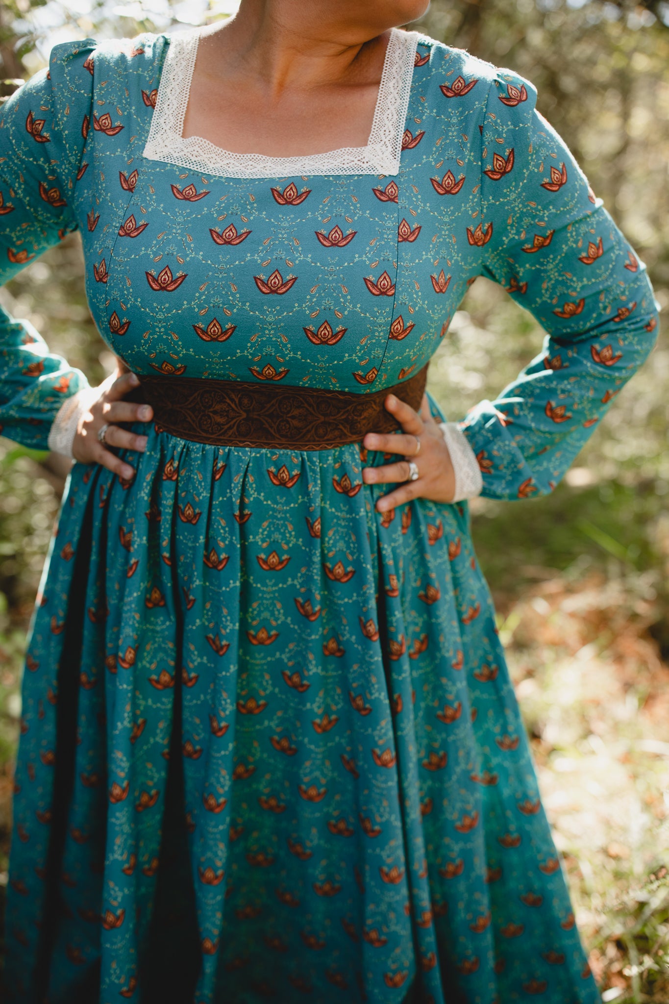 Woman in modest nursing teal patterned dress outdoors