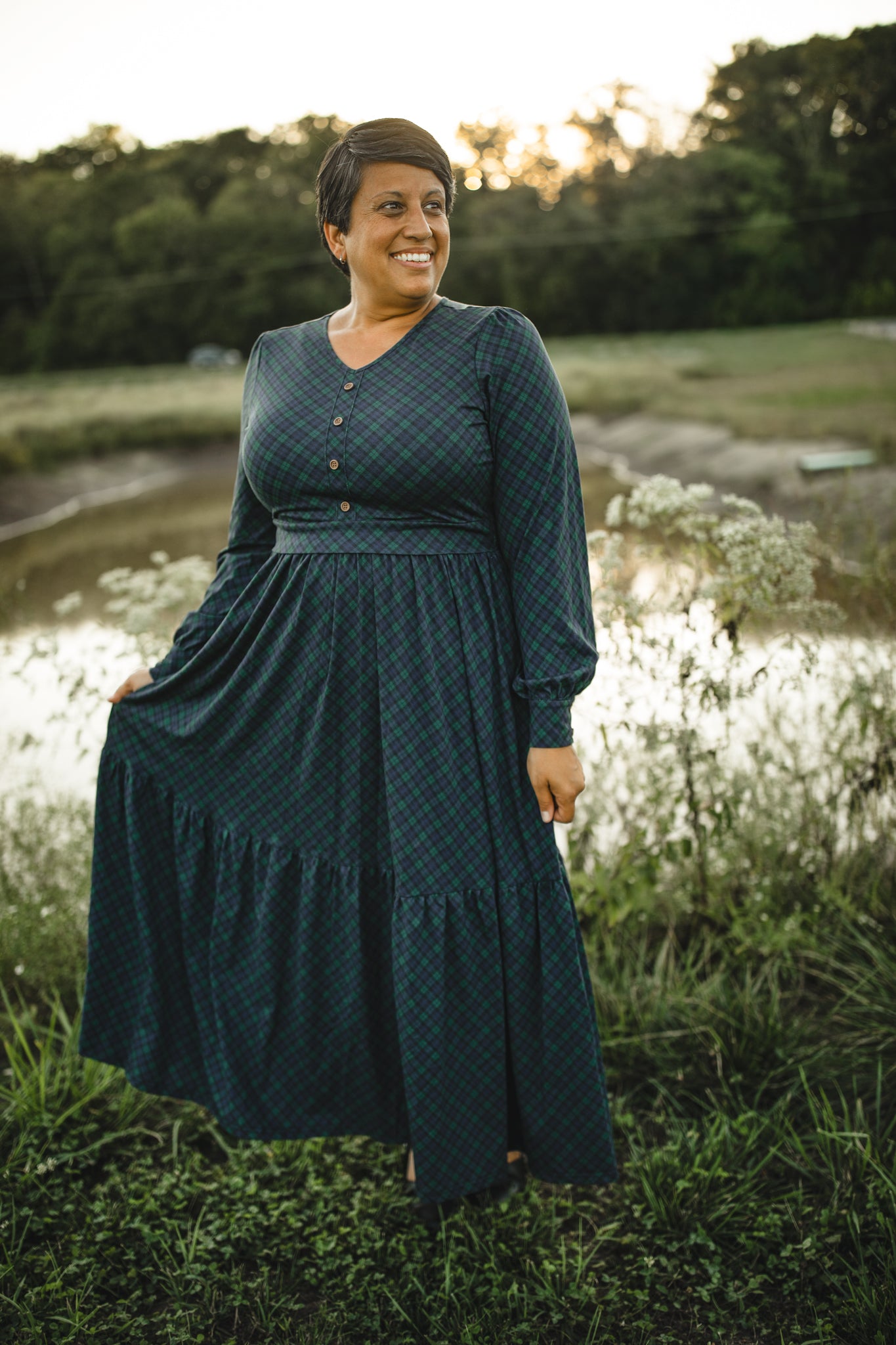 Woman in modest nursing teal dress outdoors water