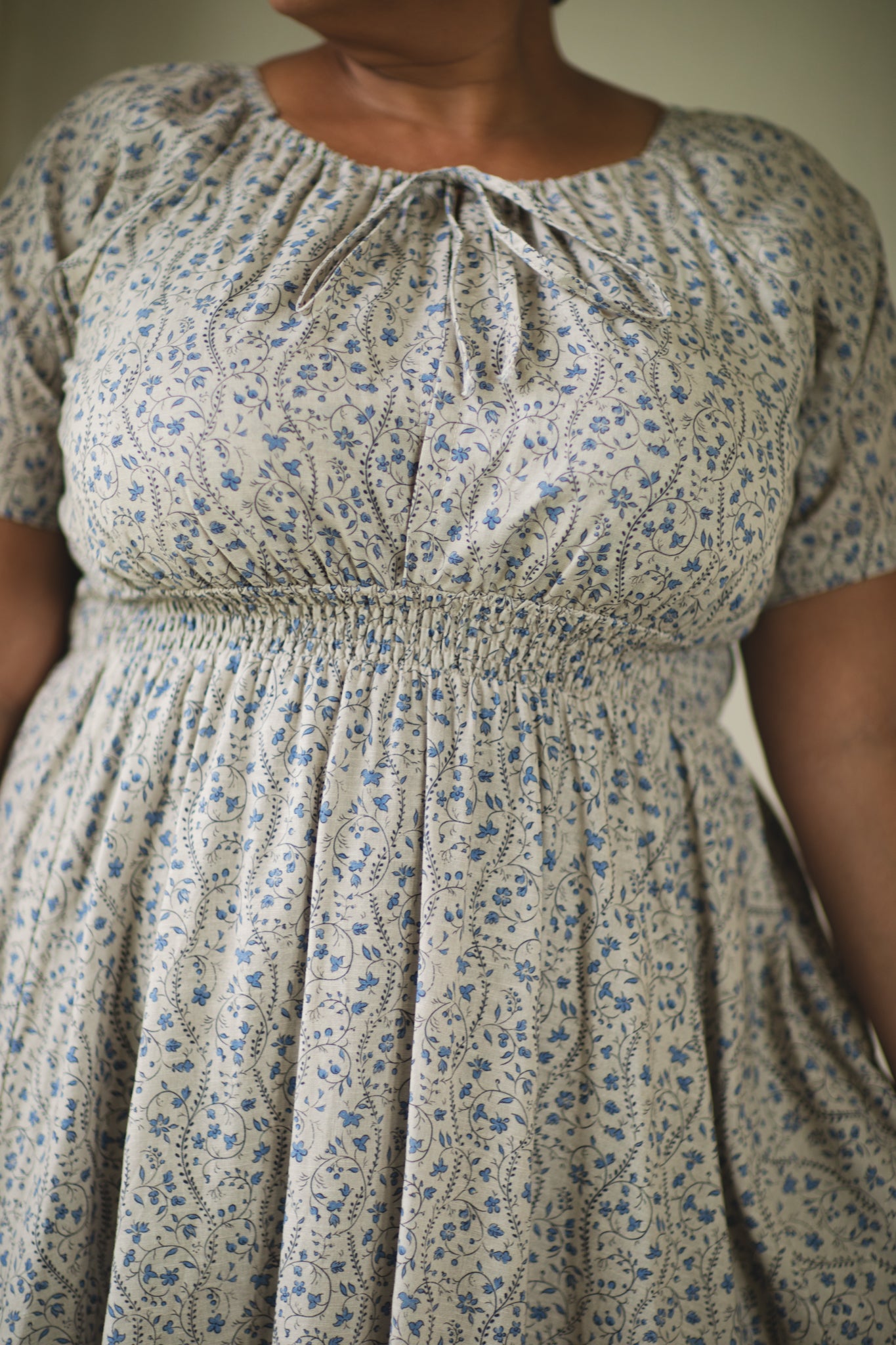 woman in patterned modest nursing dress