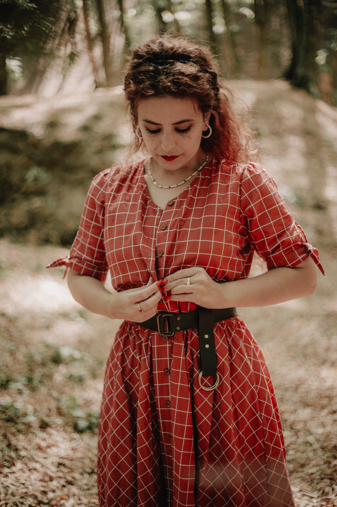 Woman in modest nursing plaid dress forest