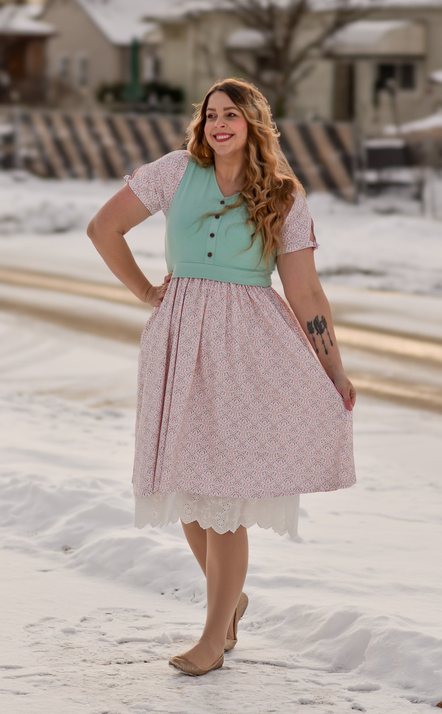 A woman wearing a vintage style modest nursing dress.