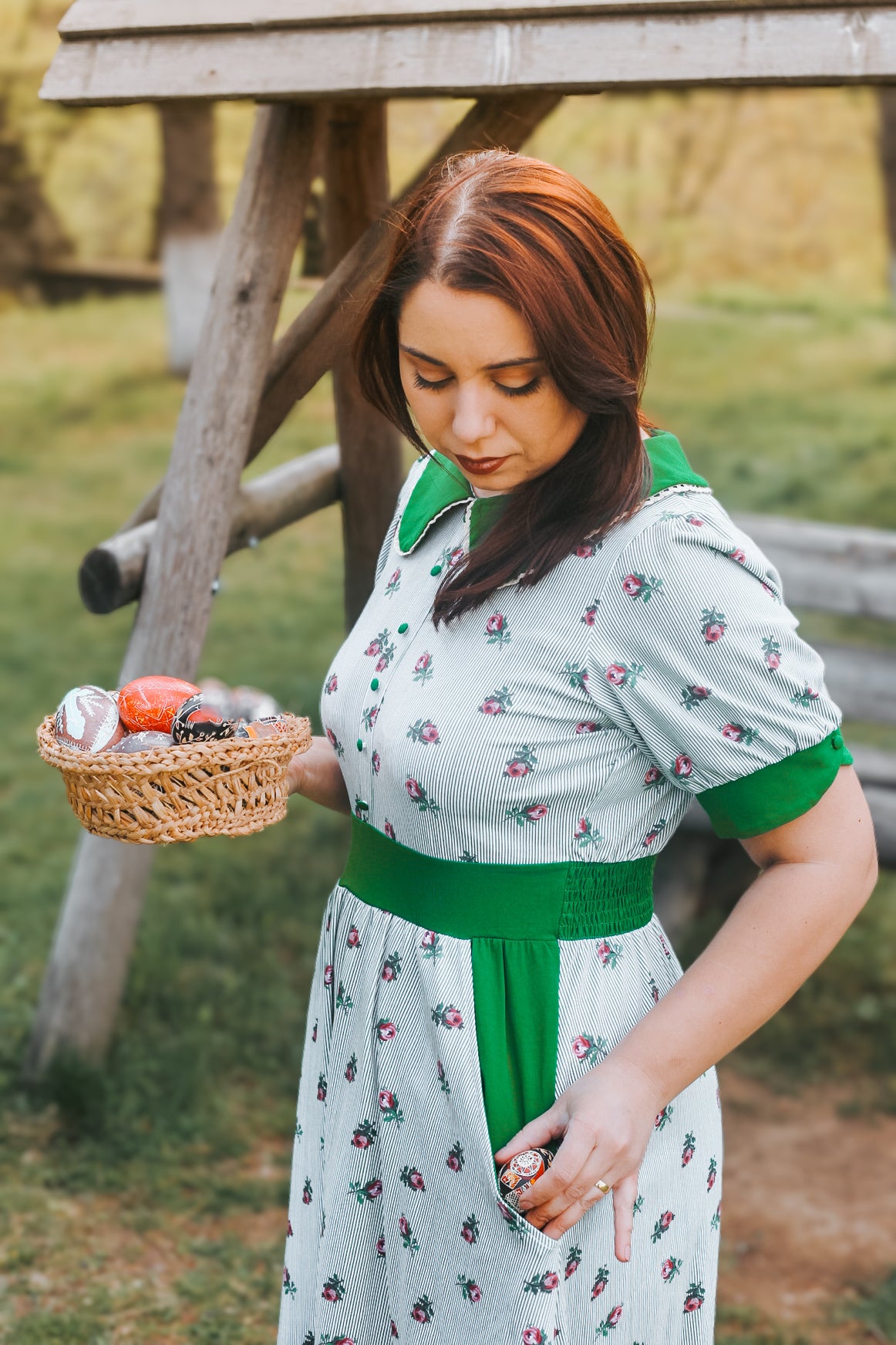 woman wearing a green and white striped modest nursing dress
