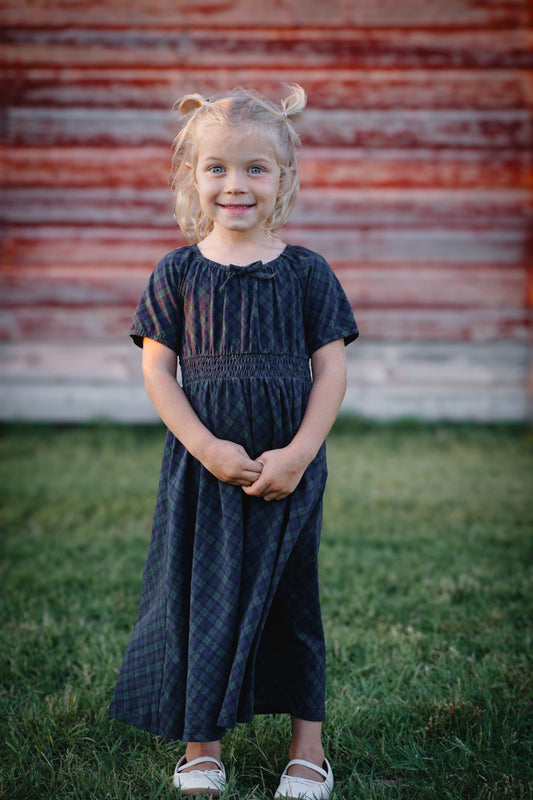 Girl wearing modest plaid dress outdoors