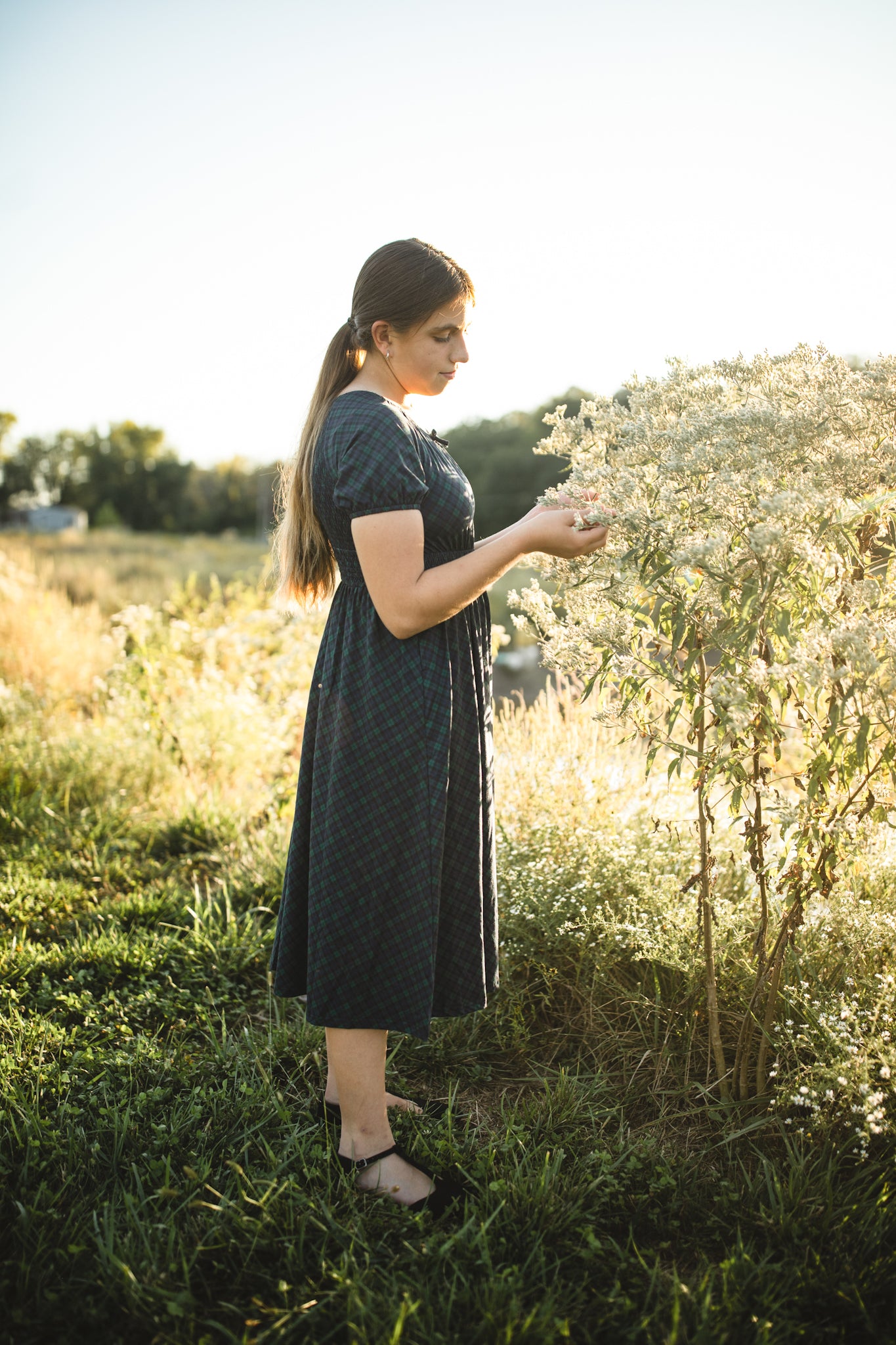 Woman in modest nursing dress holding flowers