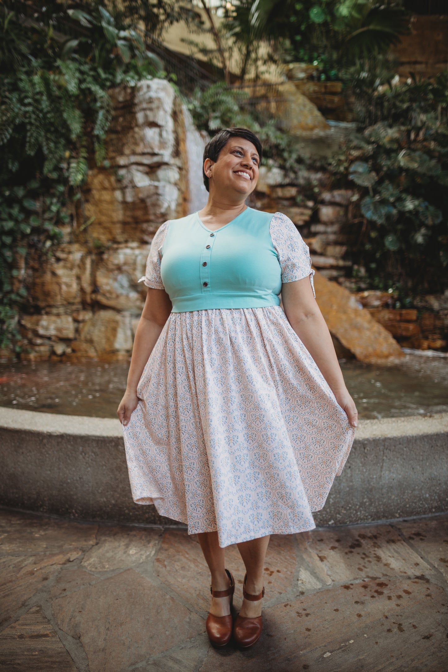 A woman wearing a vintage style modest nursing dress.