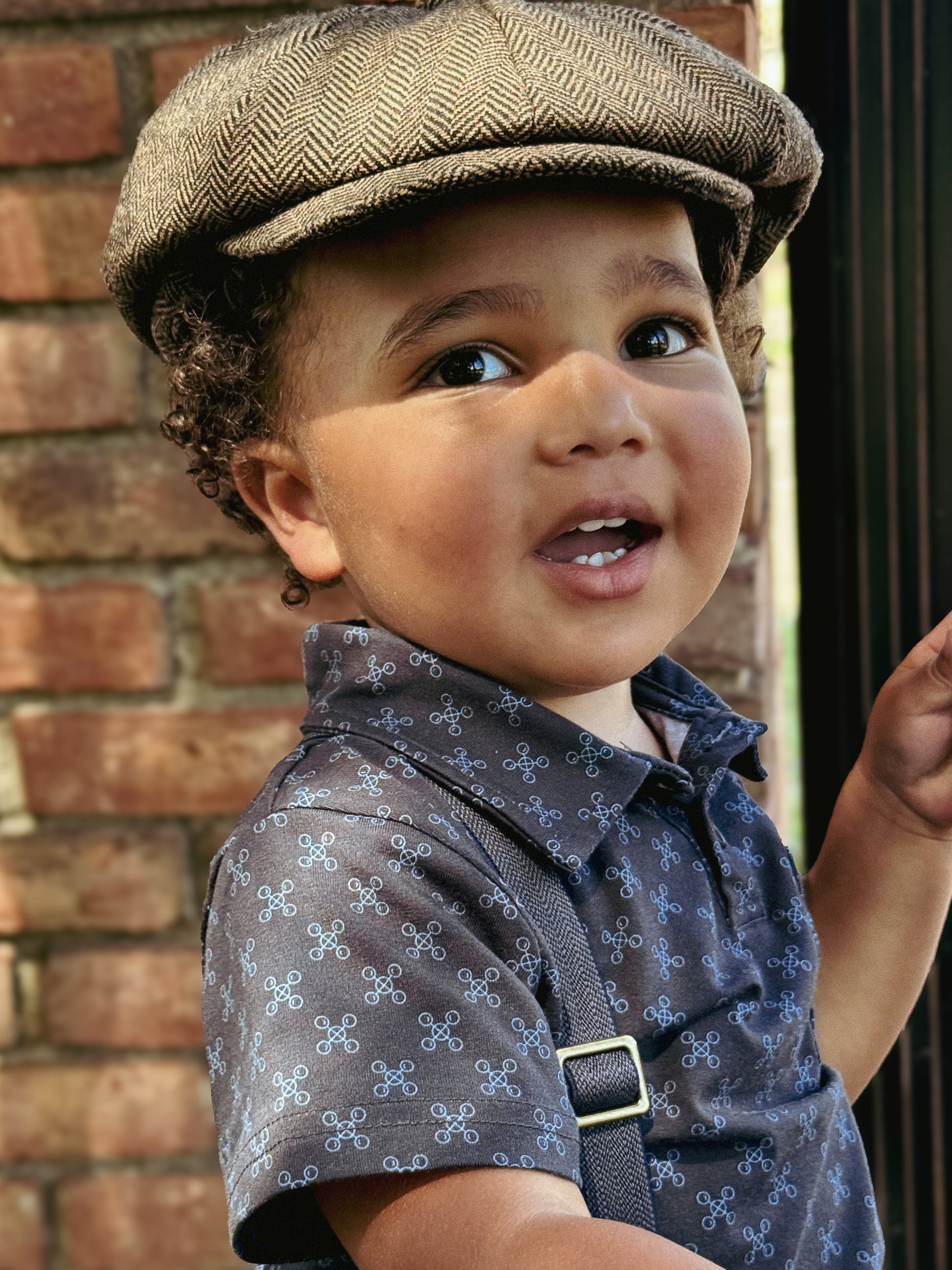 Young boy wearing a dark blue polo shirt