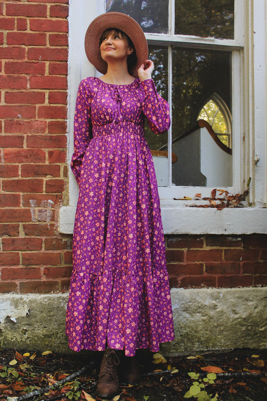 Woman in modest purple floral nursing dress