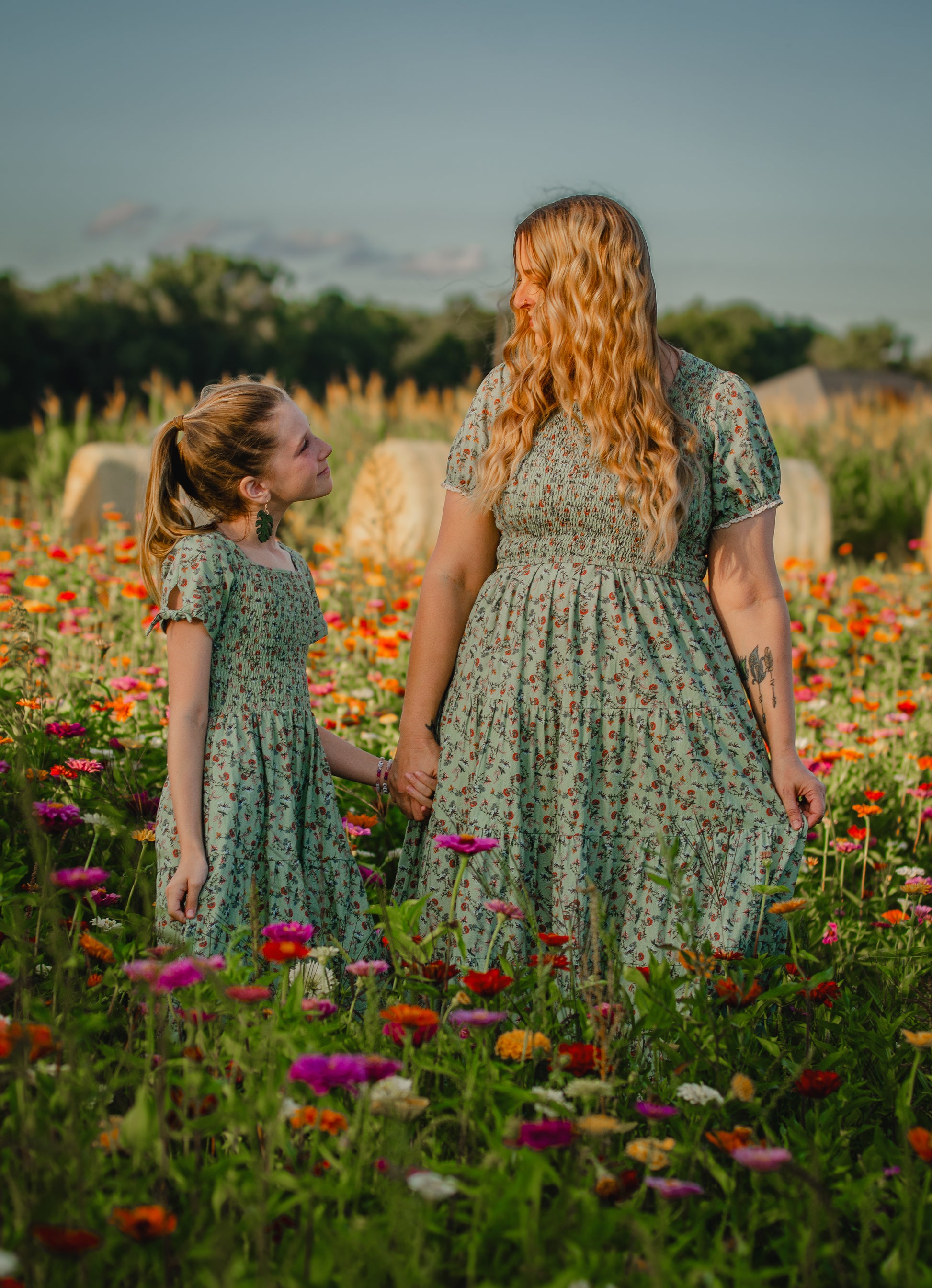 woman wearing a modest nursing green floral dress with her daughter