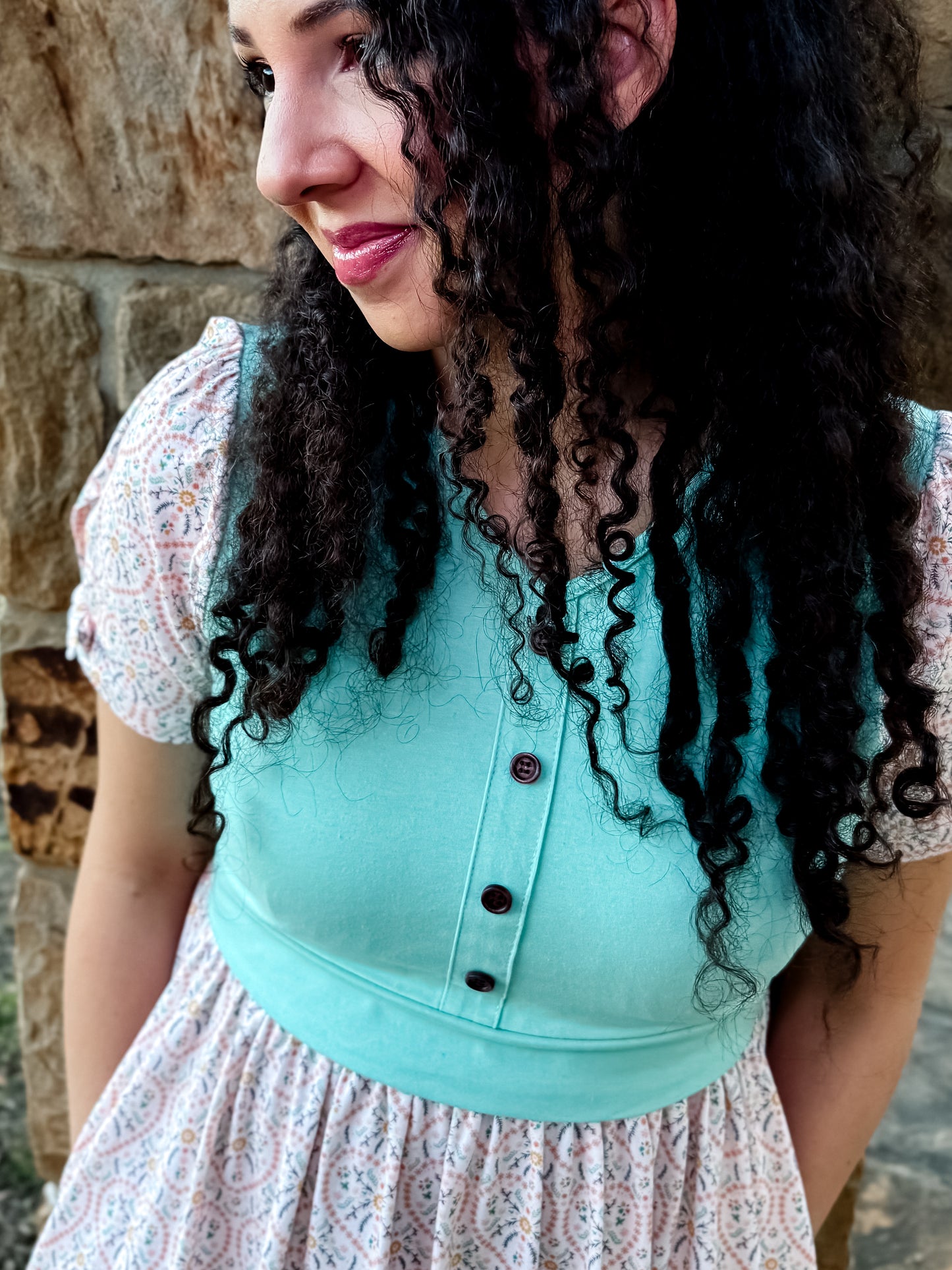 A woman wearing a vintage style modest nursing dress.