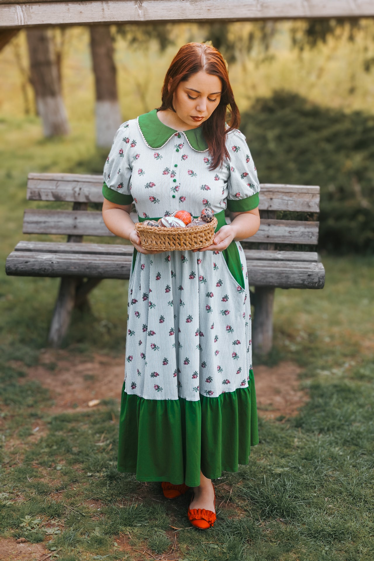woman wearing a green and white striped modest nursing dress