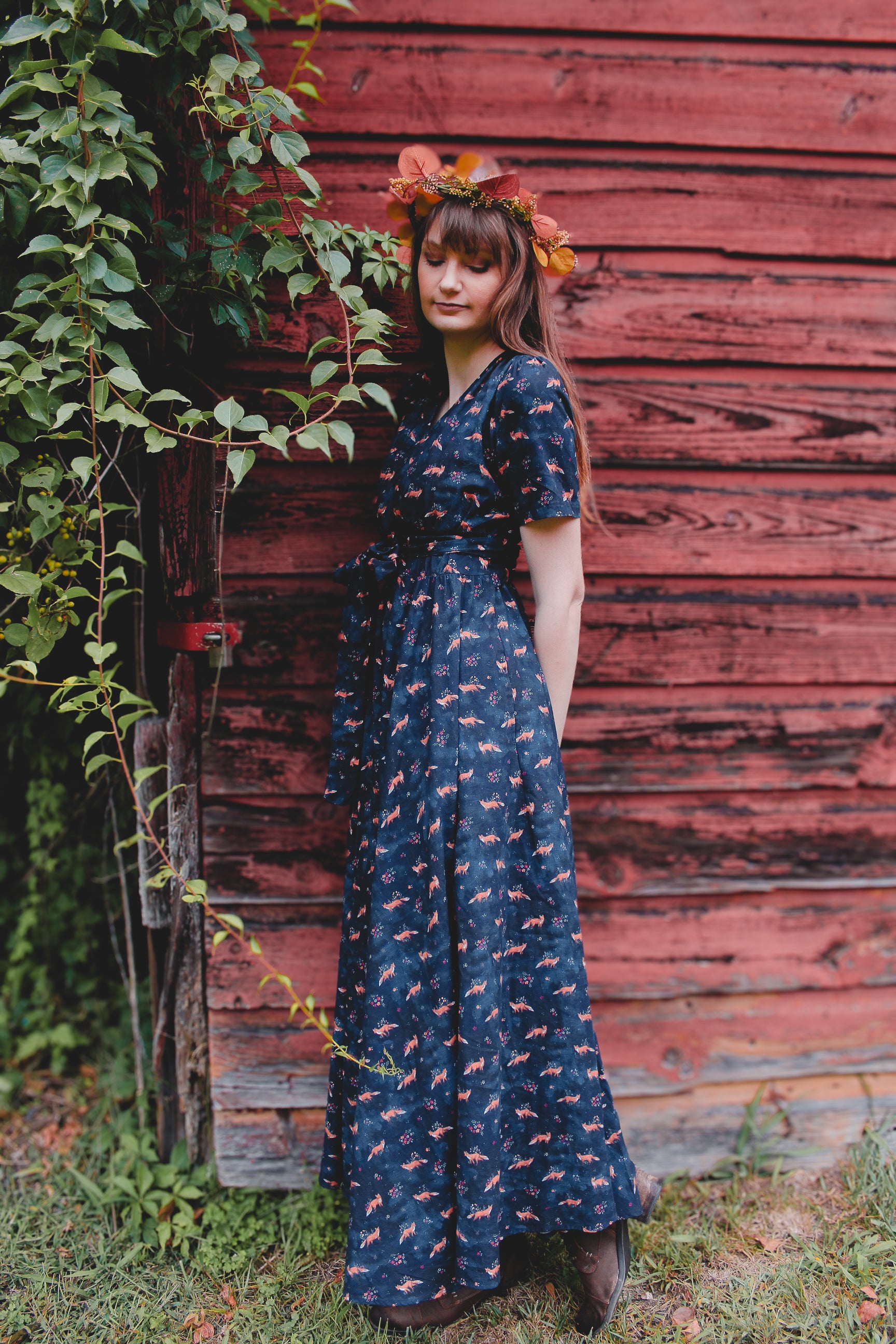 Woman in modest nursing dress, red wall