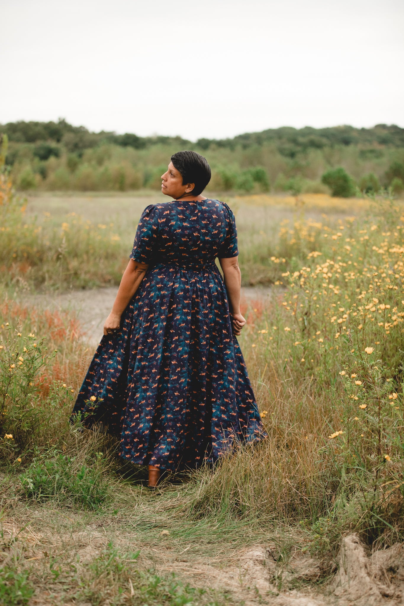 Woman in modest nursing dress, wildflowers, field