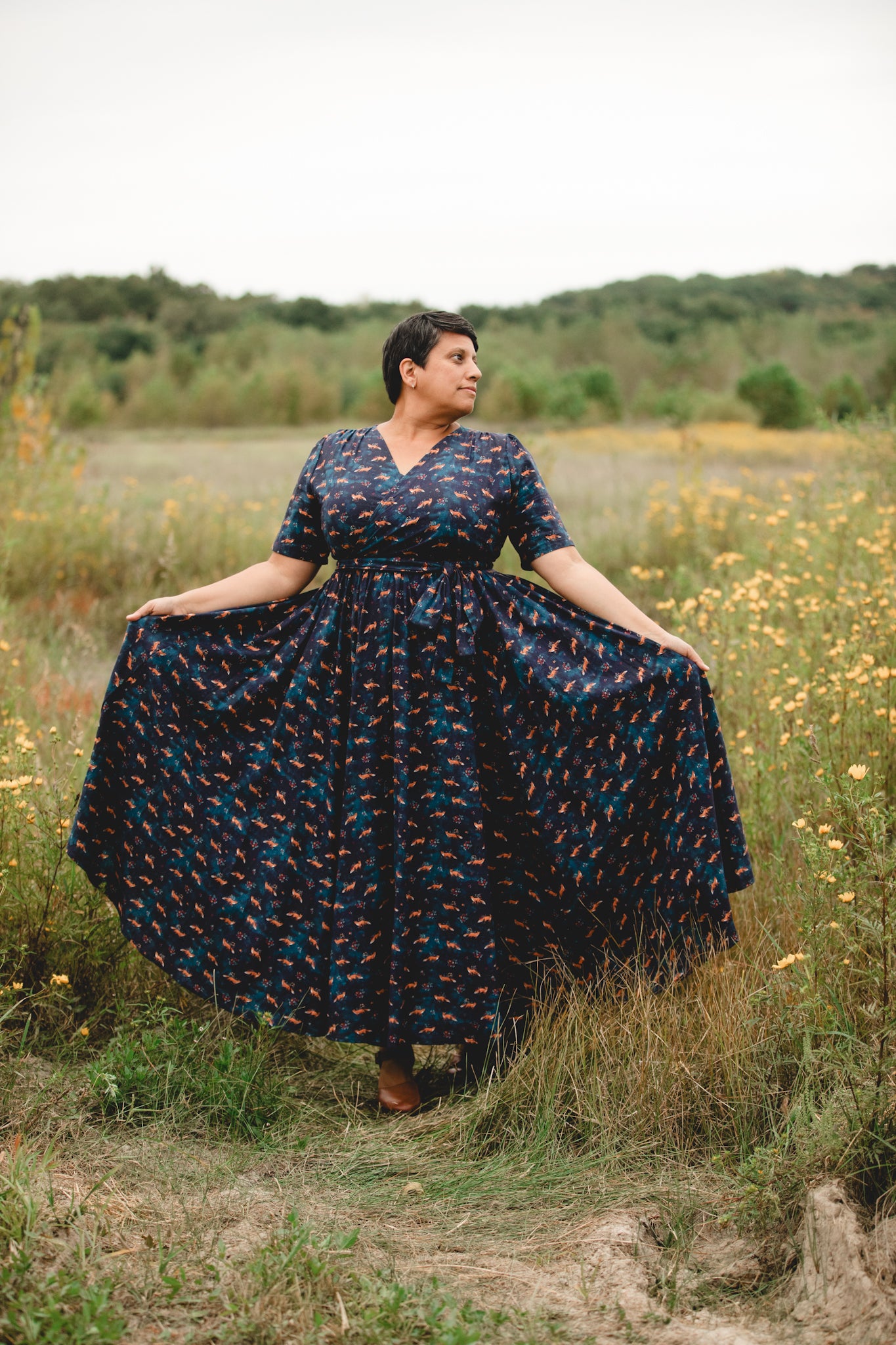 Woman in modest nursing dress, field wildflowers