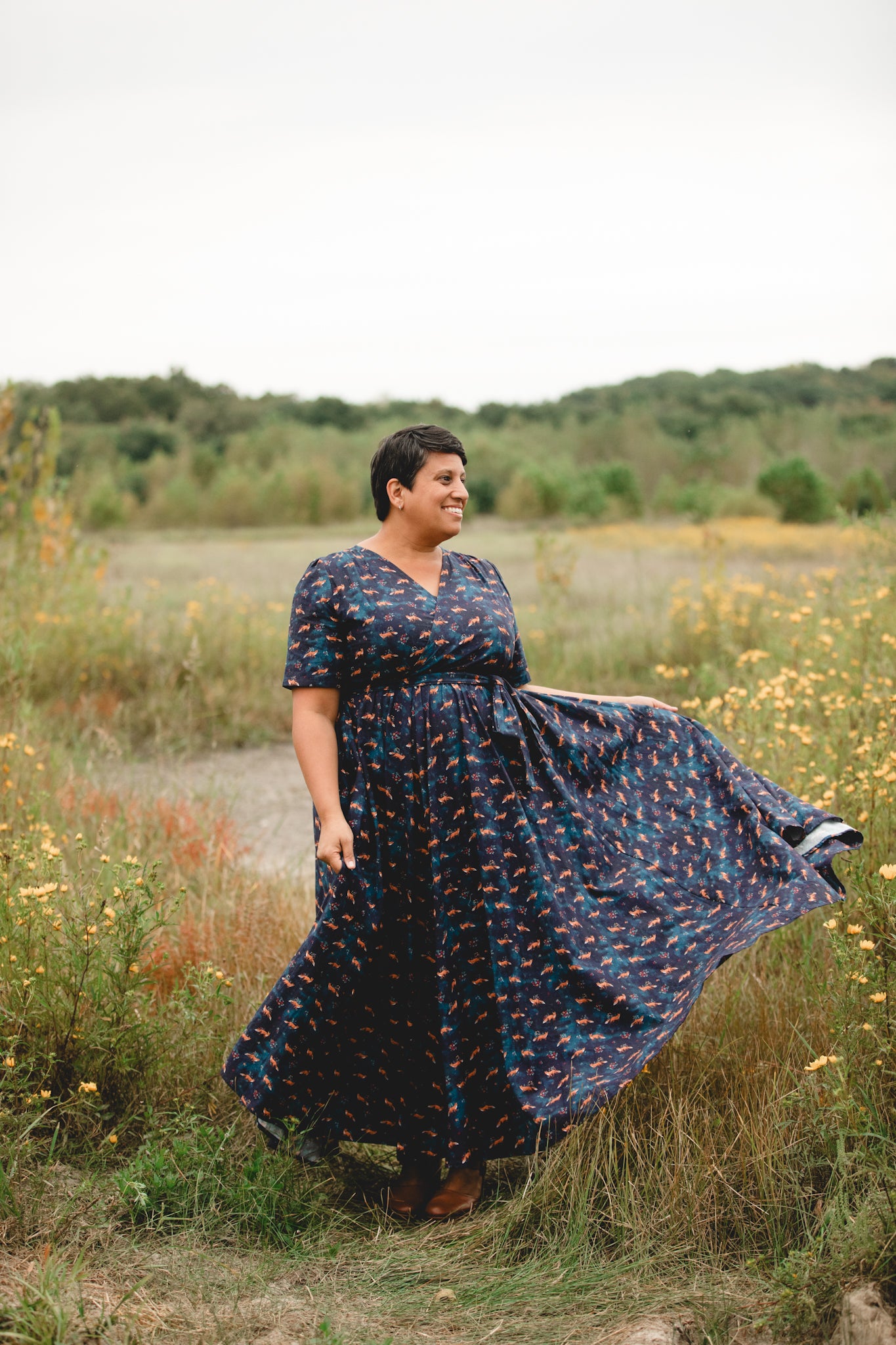 Woman in modest nursing dress, wildflowers, field