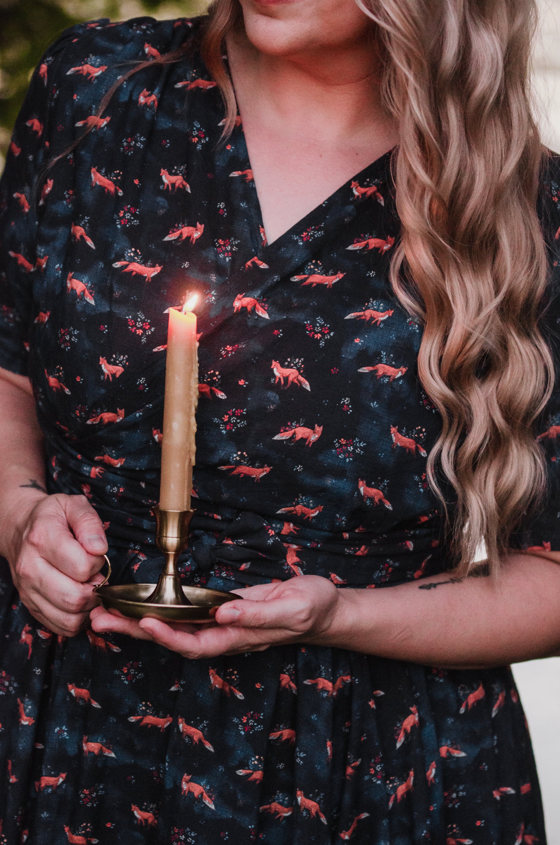 Woman in modest nursing dress holding candle