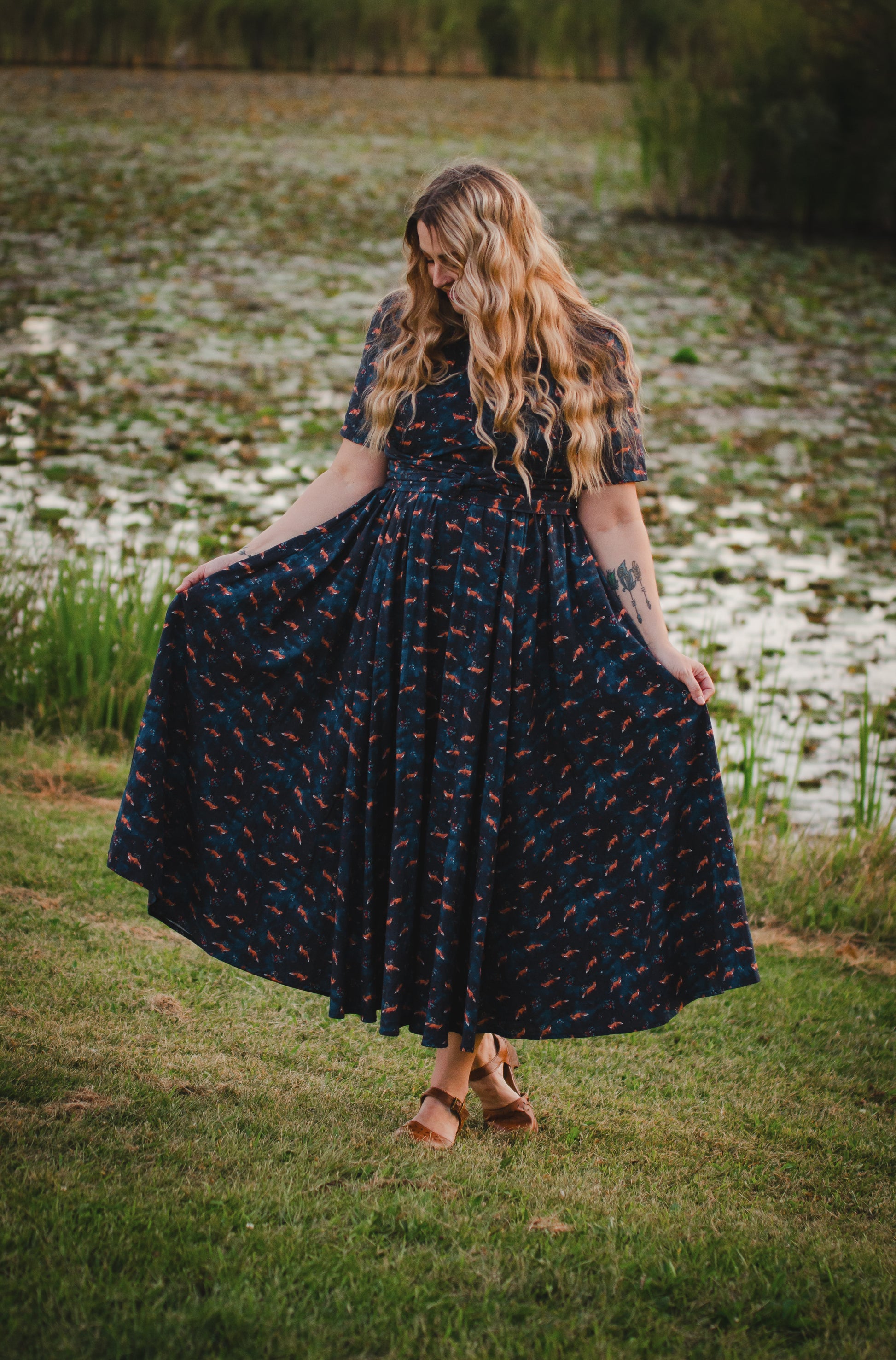 Woman in modest nursing dress, grassy field