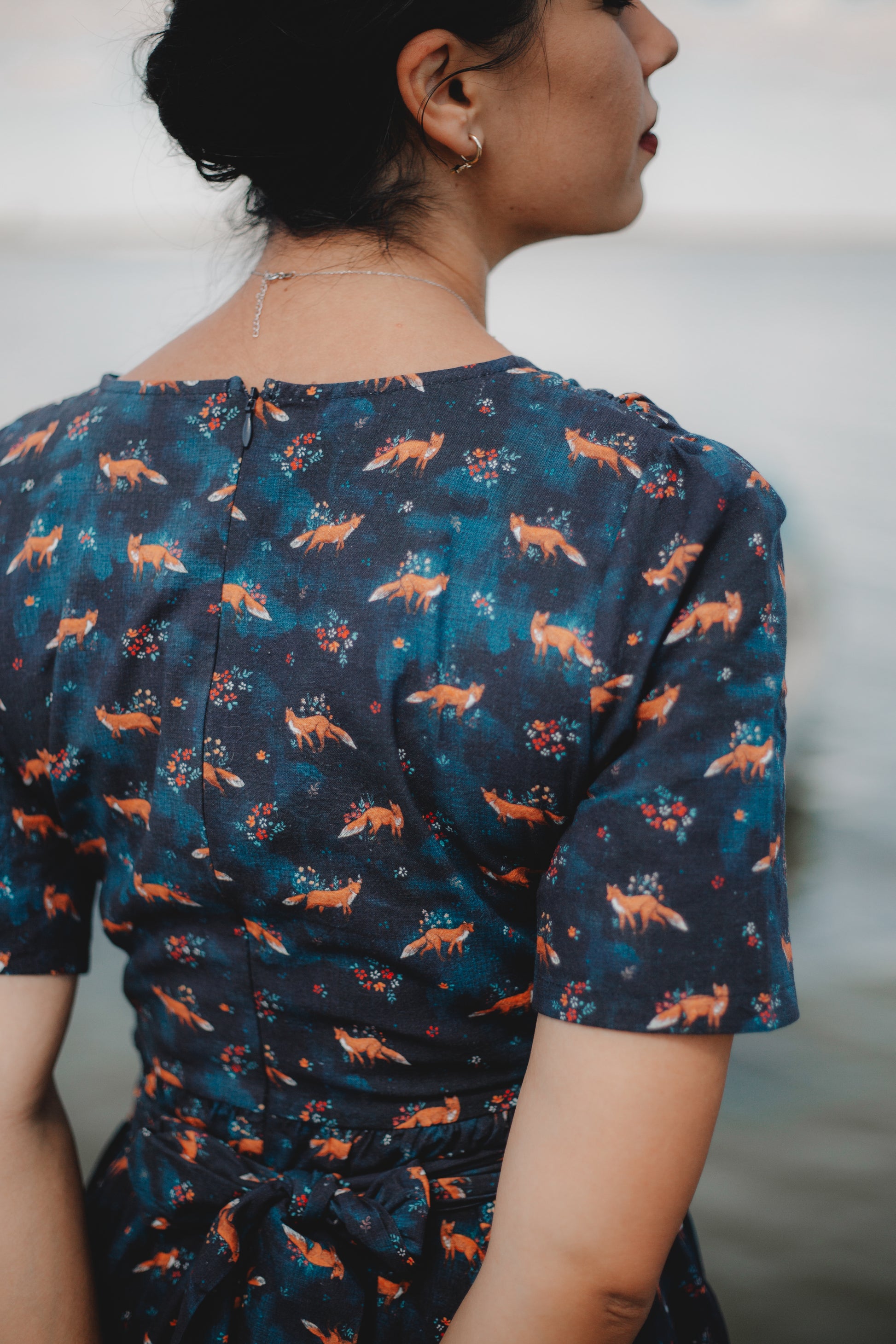 Woman in modest nursing dress with foxes