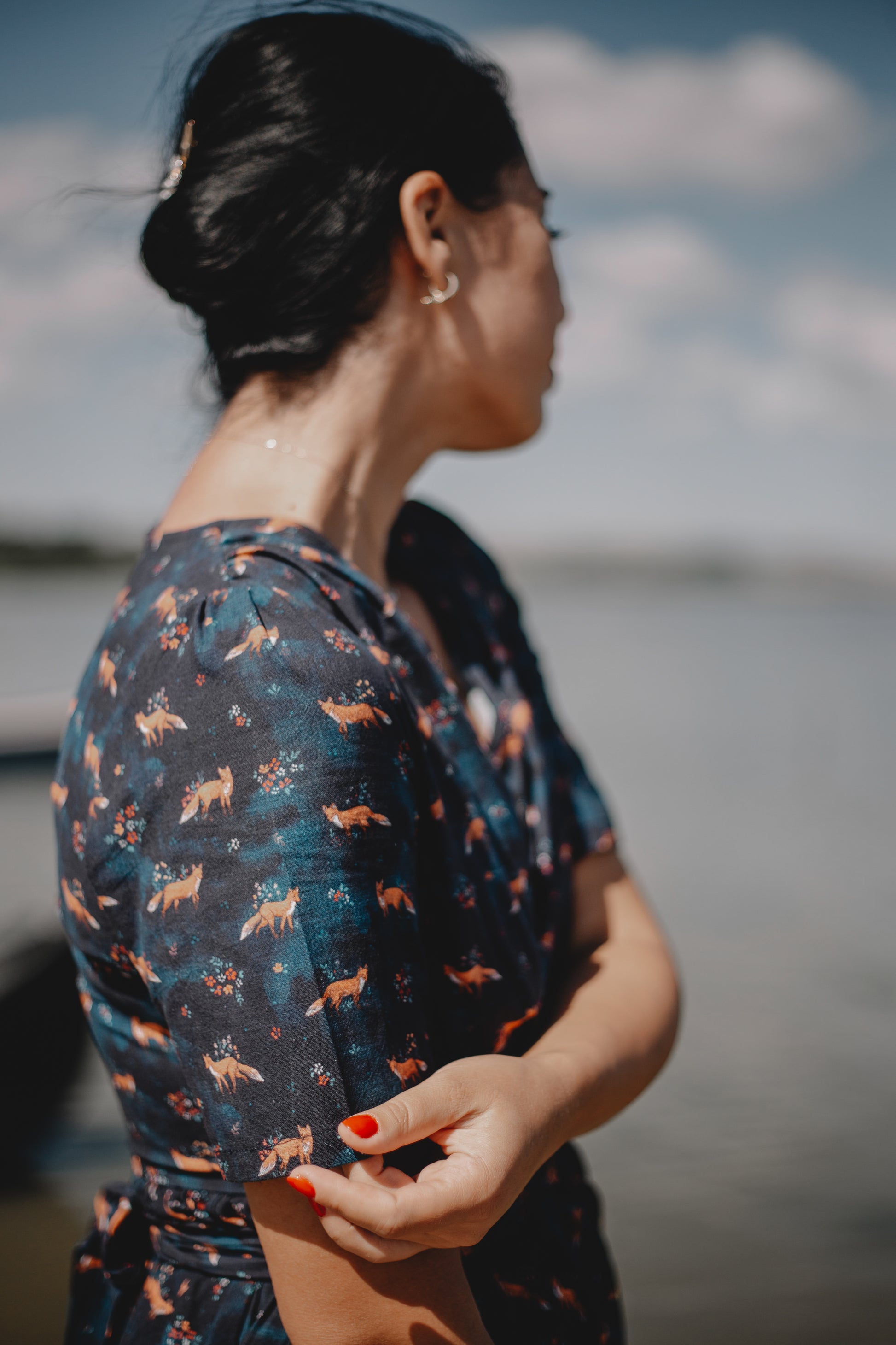 Woman in modest nursing dress by water