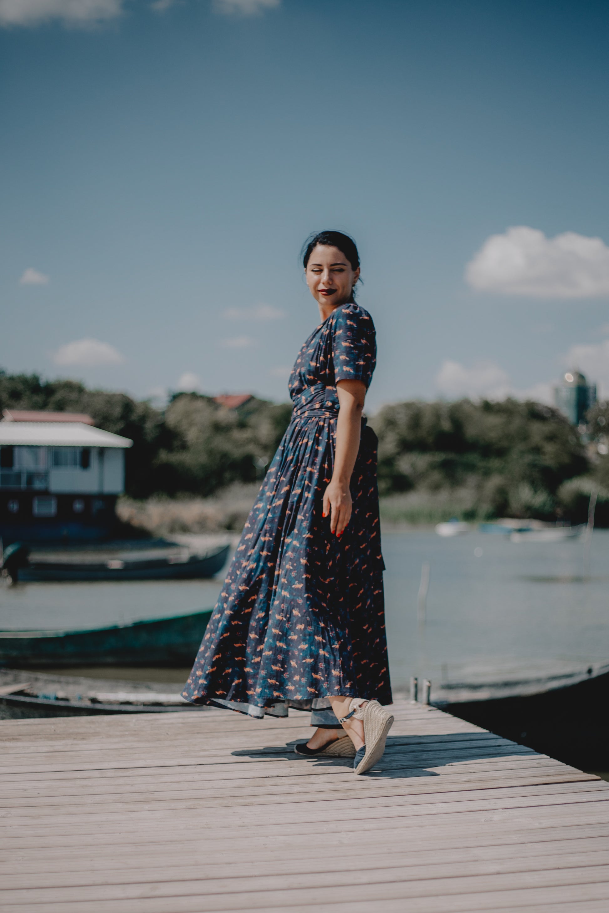 Woman in modest nursing dress on dock