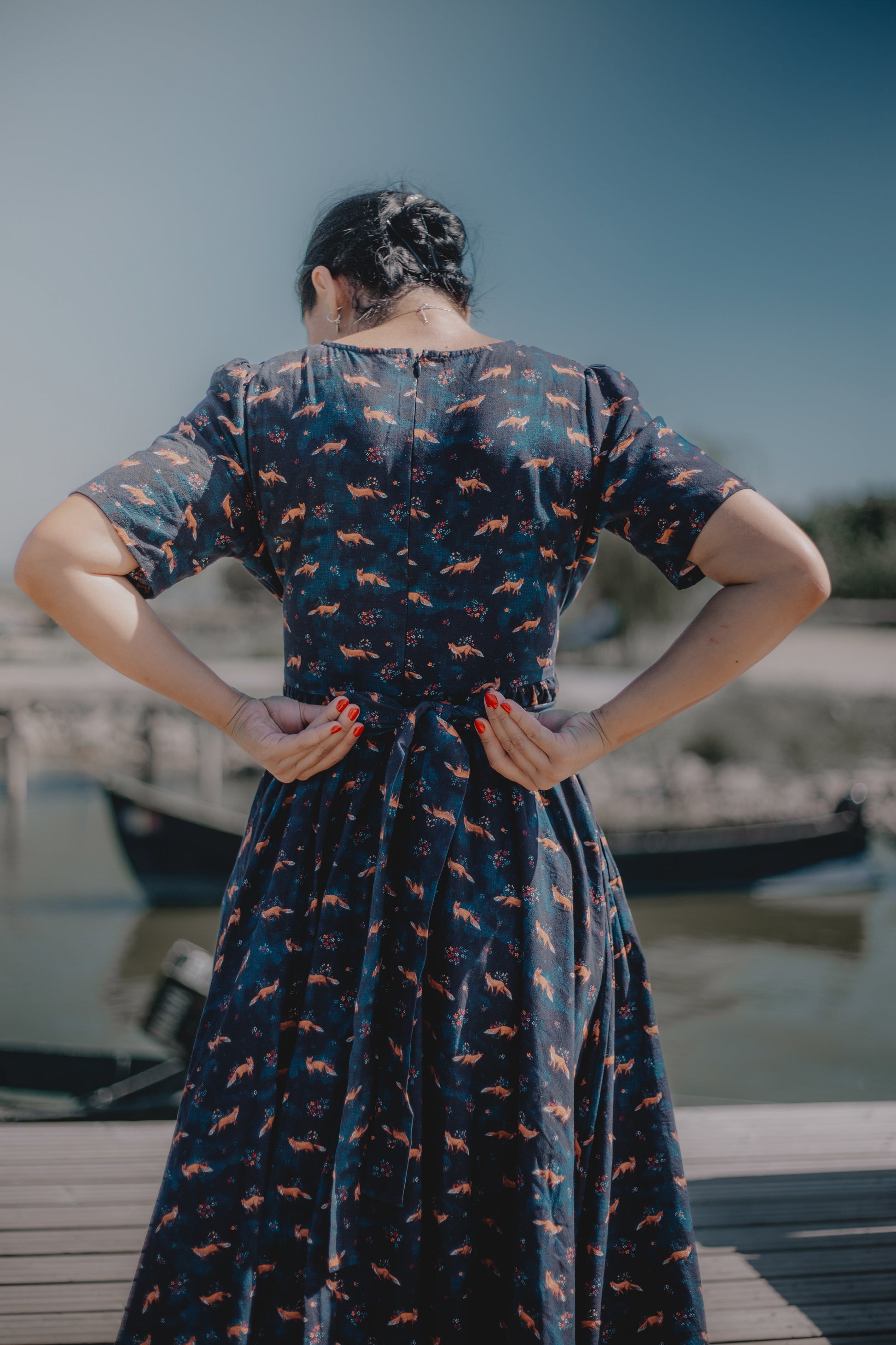 Woman in modest nursing dress on dock