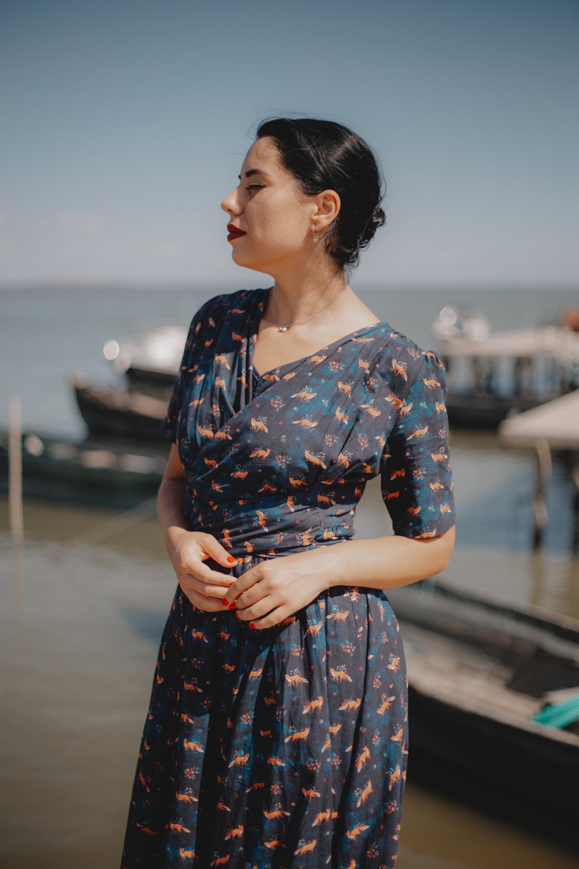 Woman in modest nursing dress by waterfront