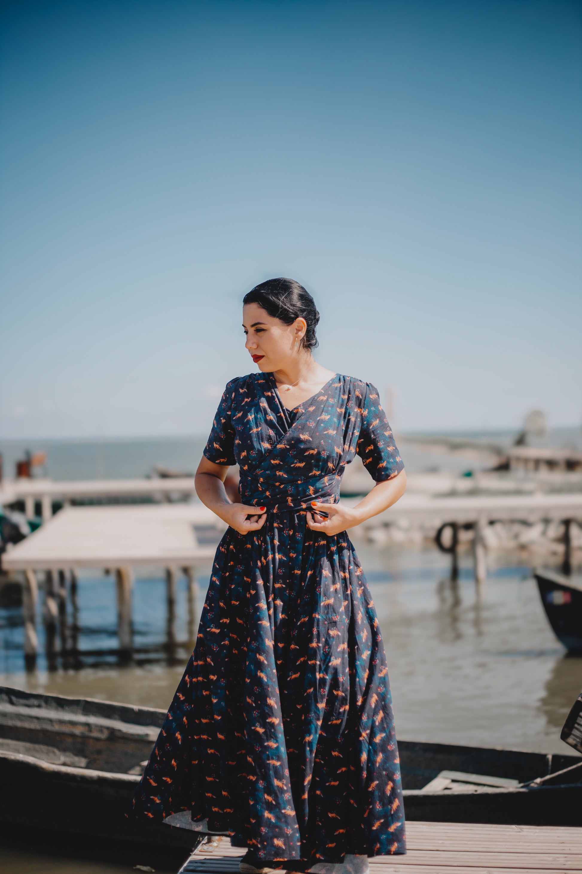Woman in modest nursing dress on dock