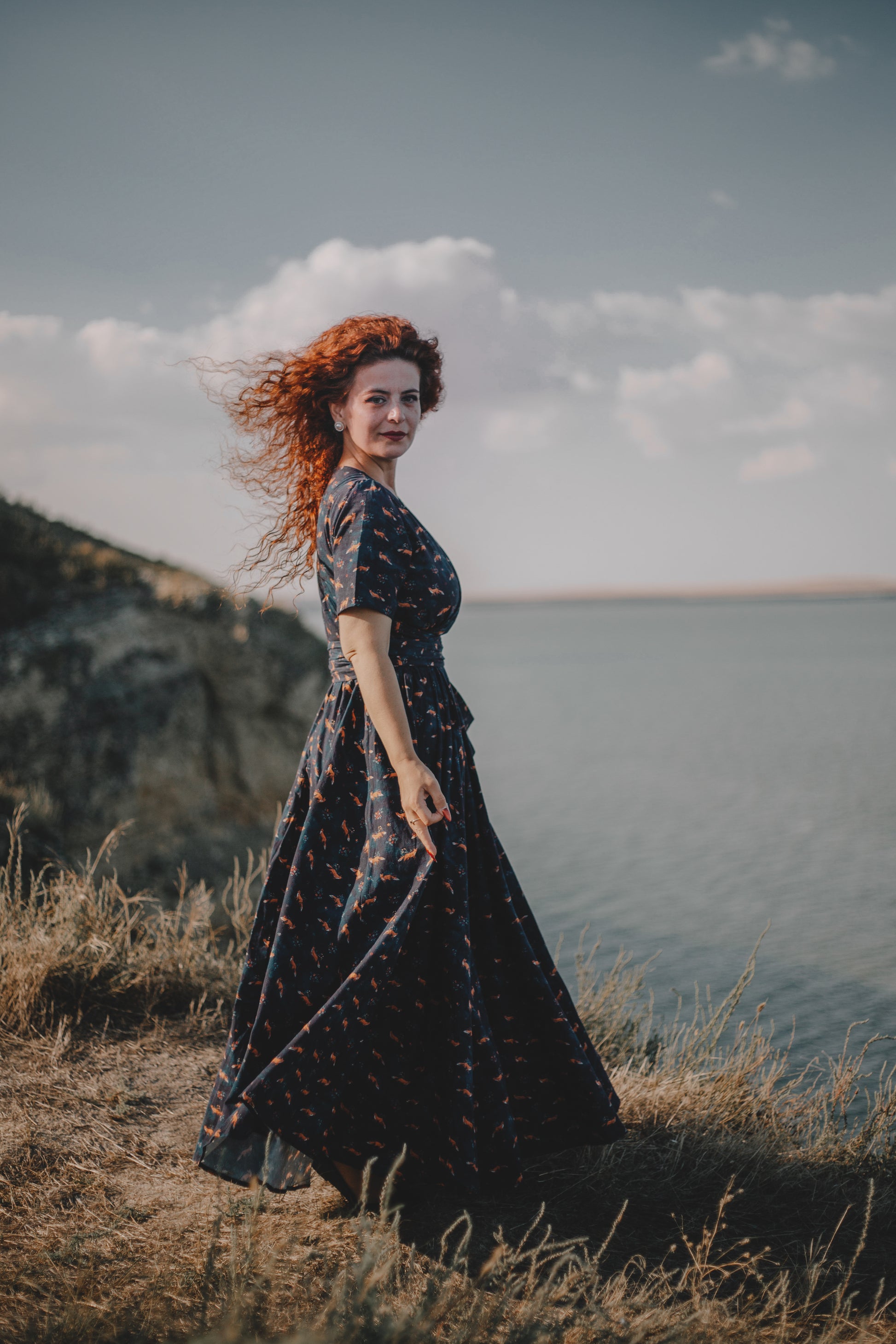 Woman in modest nursing dress overlooking water