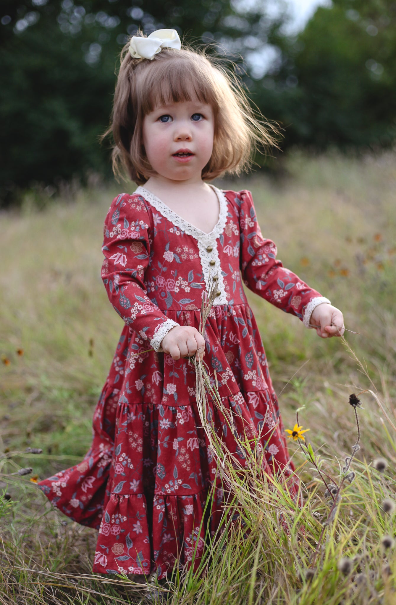 Young girl in modest red floral dress outdoors