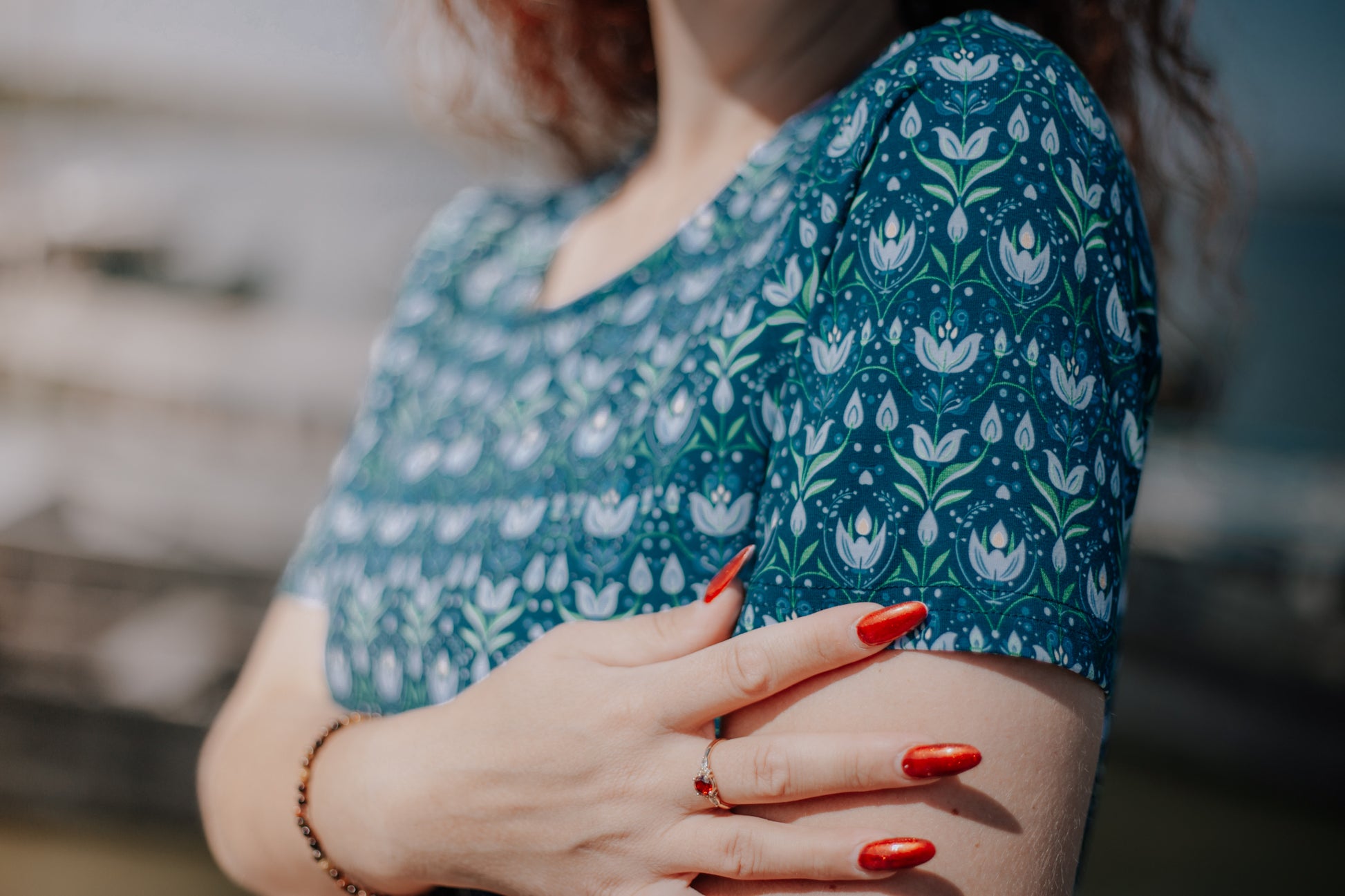 Woman in modest nursing dress, pattern detail.