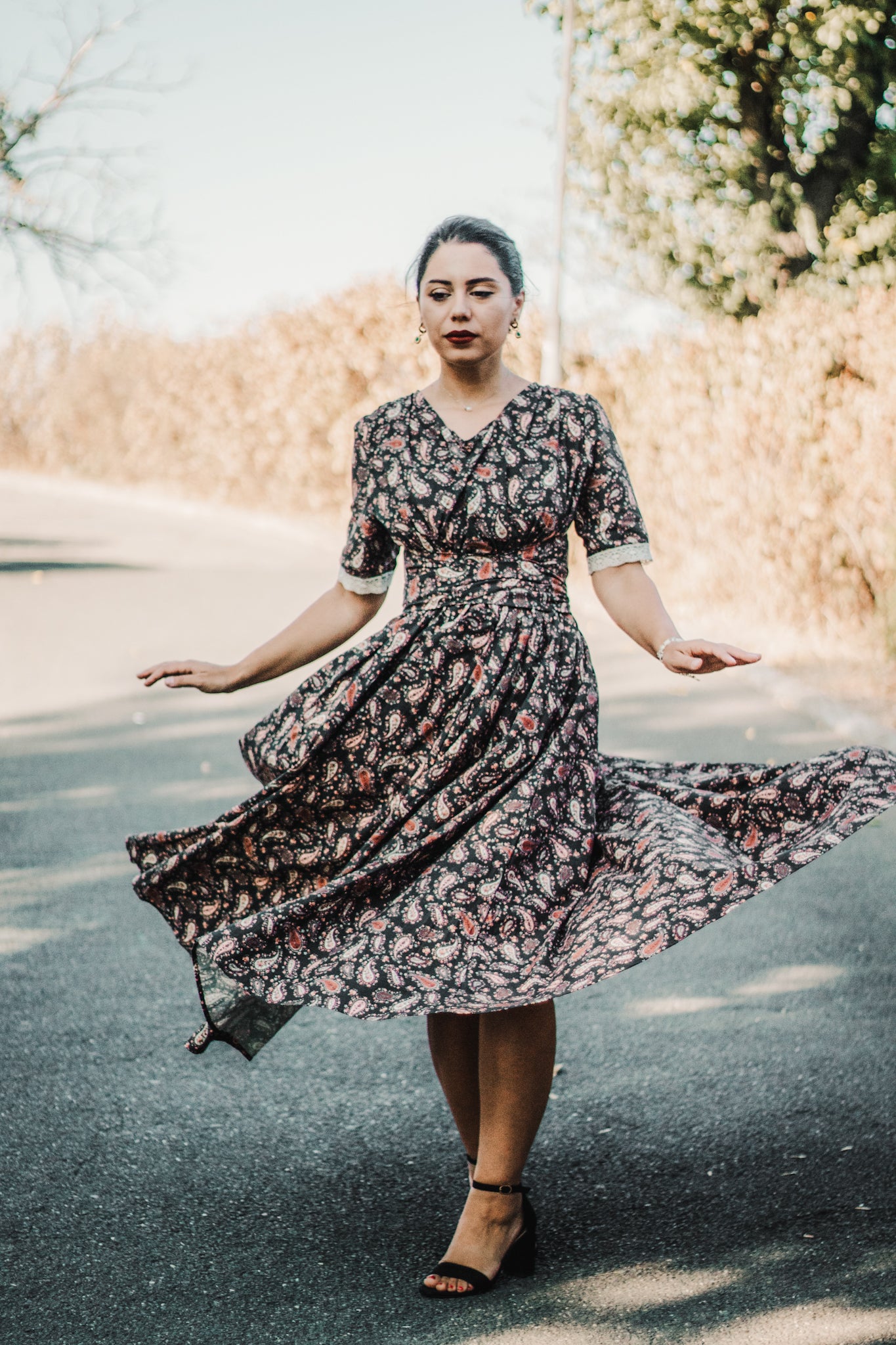 Woman in modest nursing dress standing on road