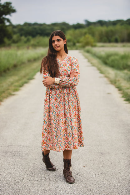 Woman wearing a patterned modest nursing dress