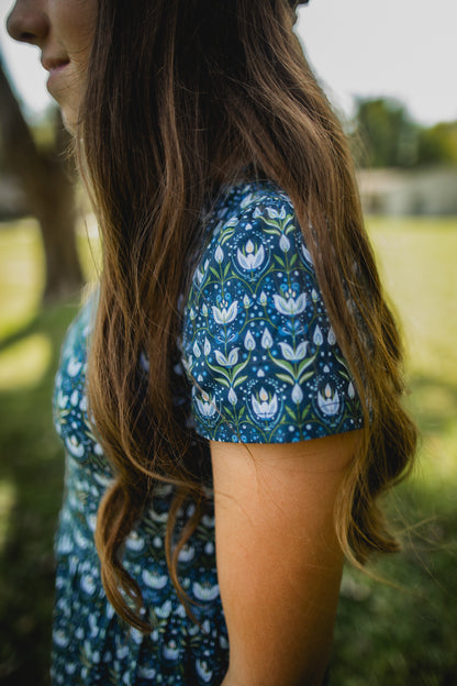 Woman in modest nursing blue floral dress outdoors
