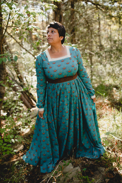 Woman in modest nursing teal patterned dress outside