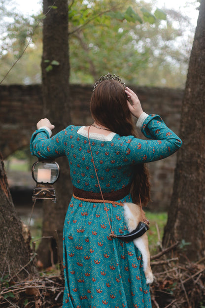 Woman in modest nursing teal dress with dog