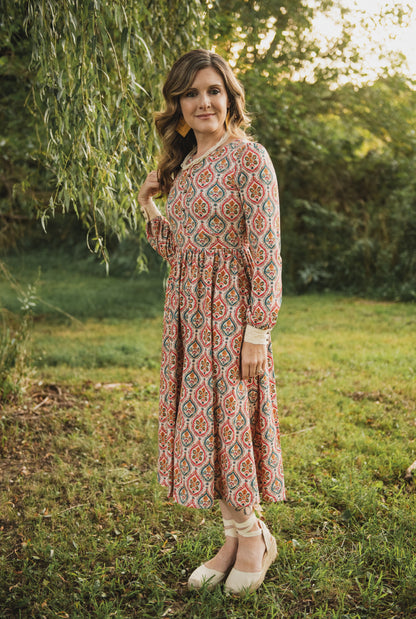 Woman wearing a patterned modest nursing dress
