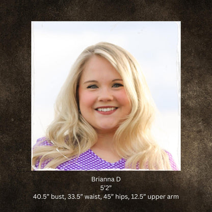 Woman with blonde hair and a purple top on a brown background