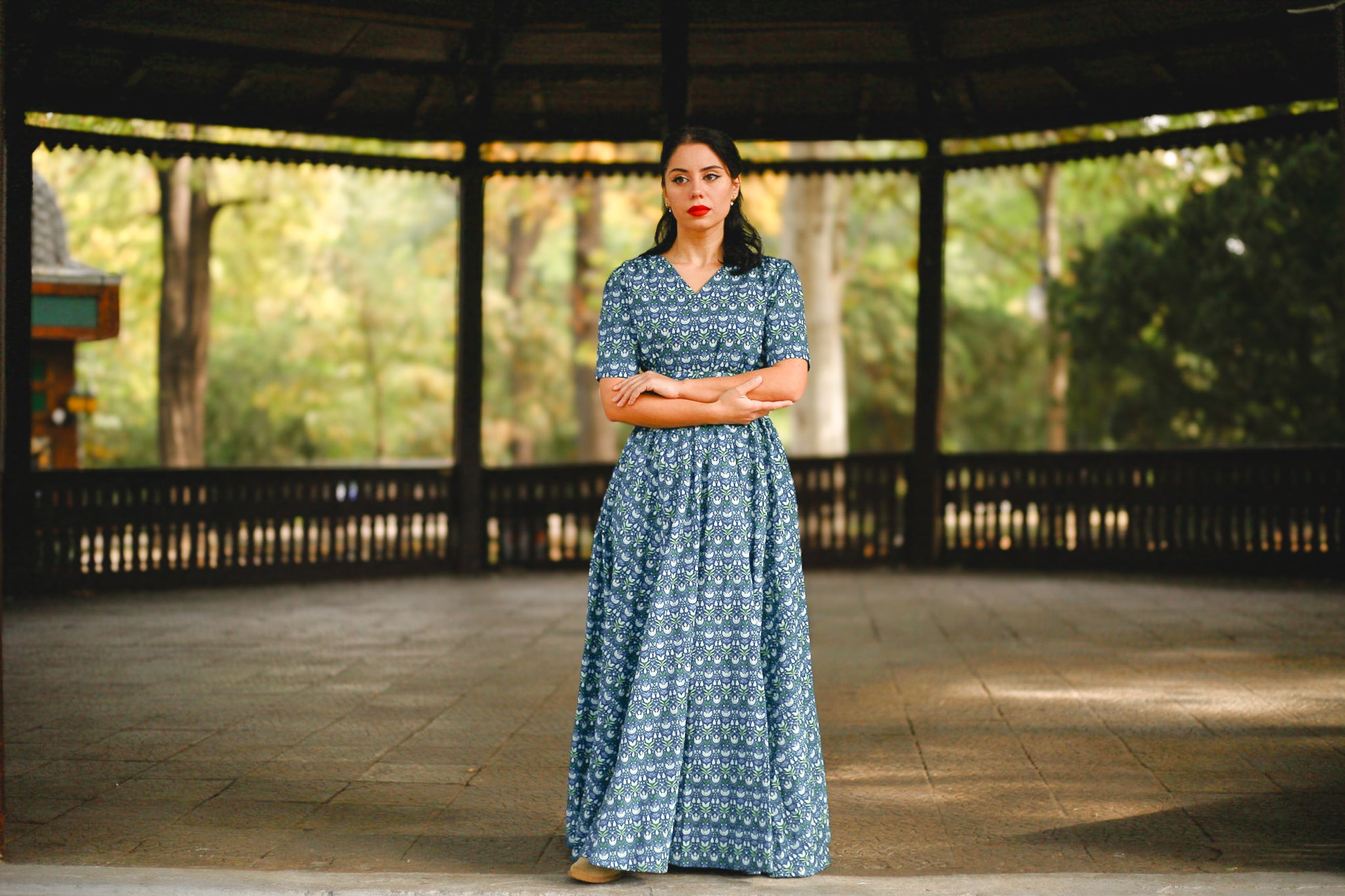 Woman in modest nursing dress in gazebo