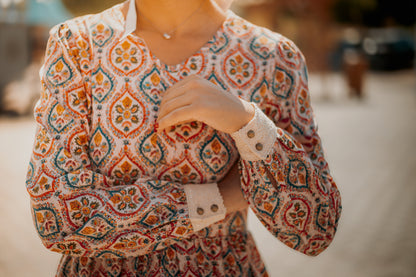 Woman wearing a patterned modest nursing dress