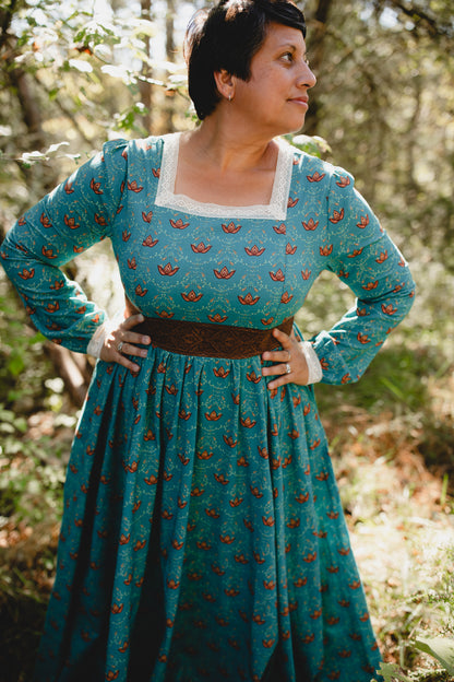 Woman in modest nursing teal patterned dress