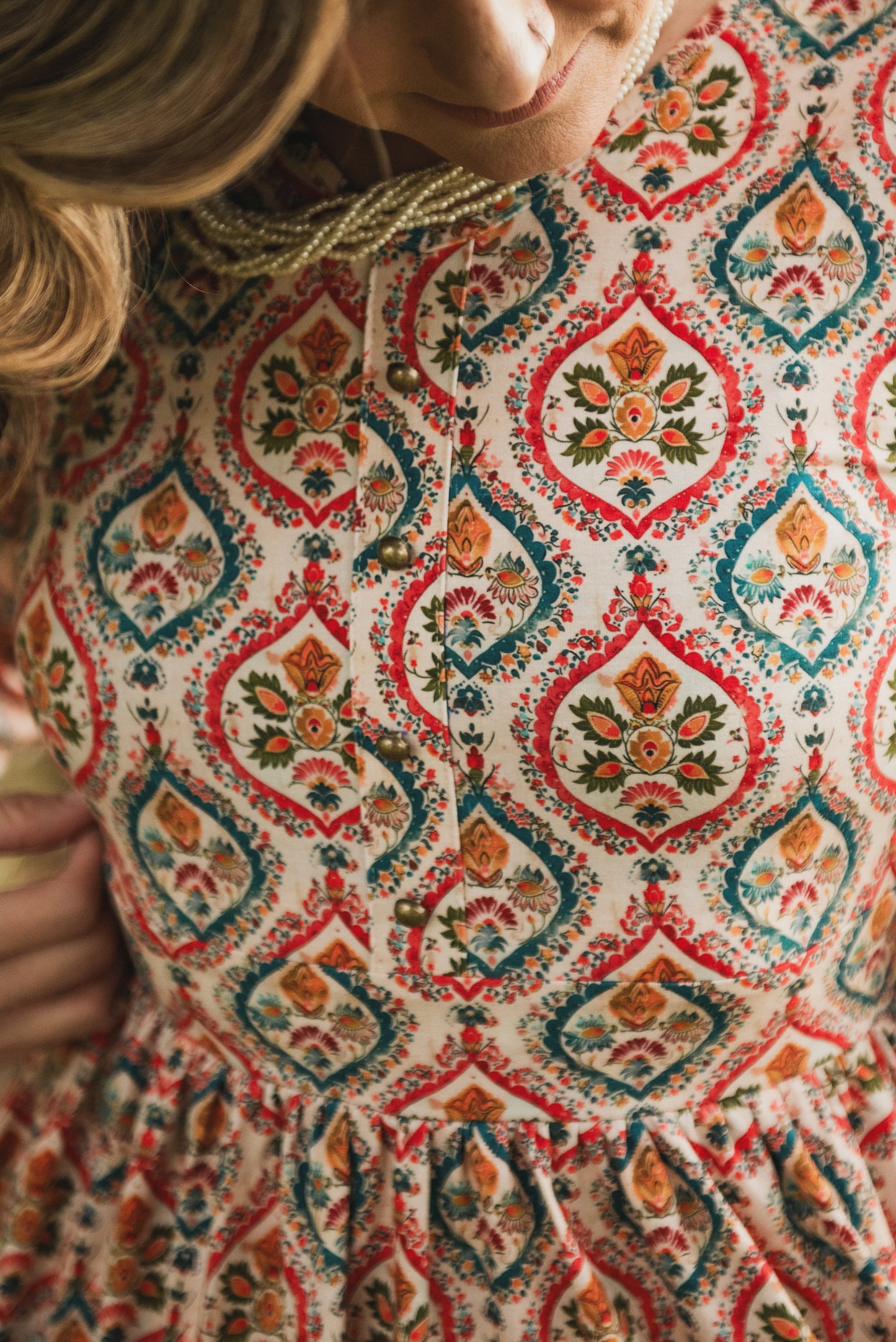 Woman wearing a patterned modest nursing dress
