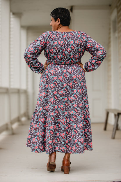 Woman in modest nursing floral dress on porch