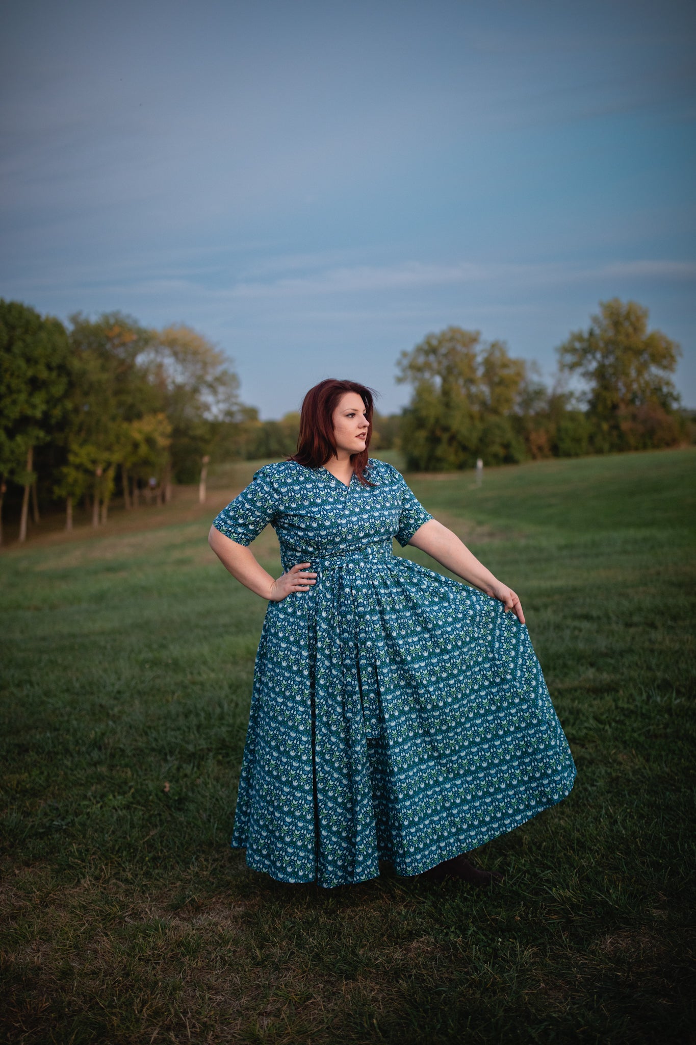 Woman in modest nursing dress in field