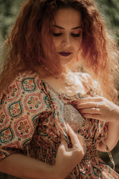 Woman wearing a patterned modest nursing dress
