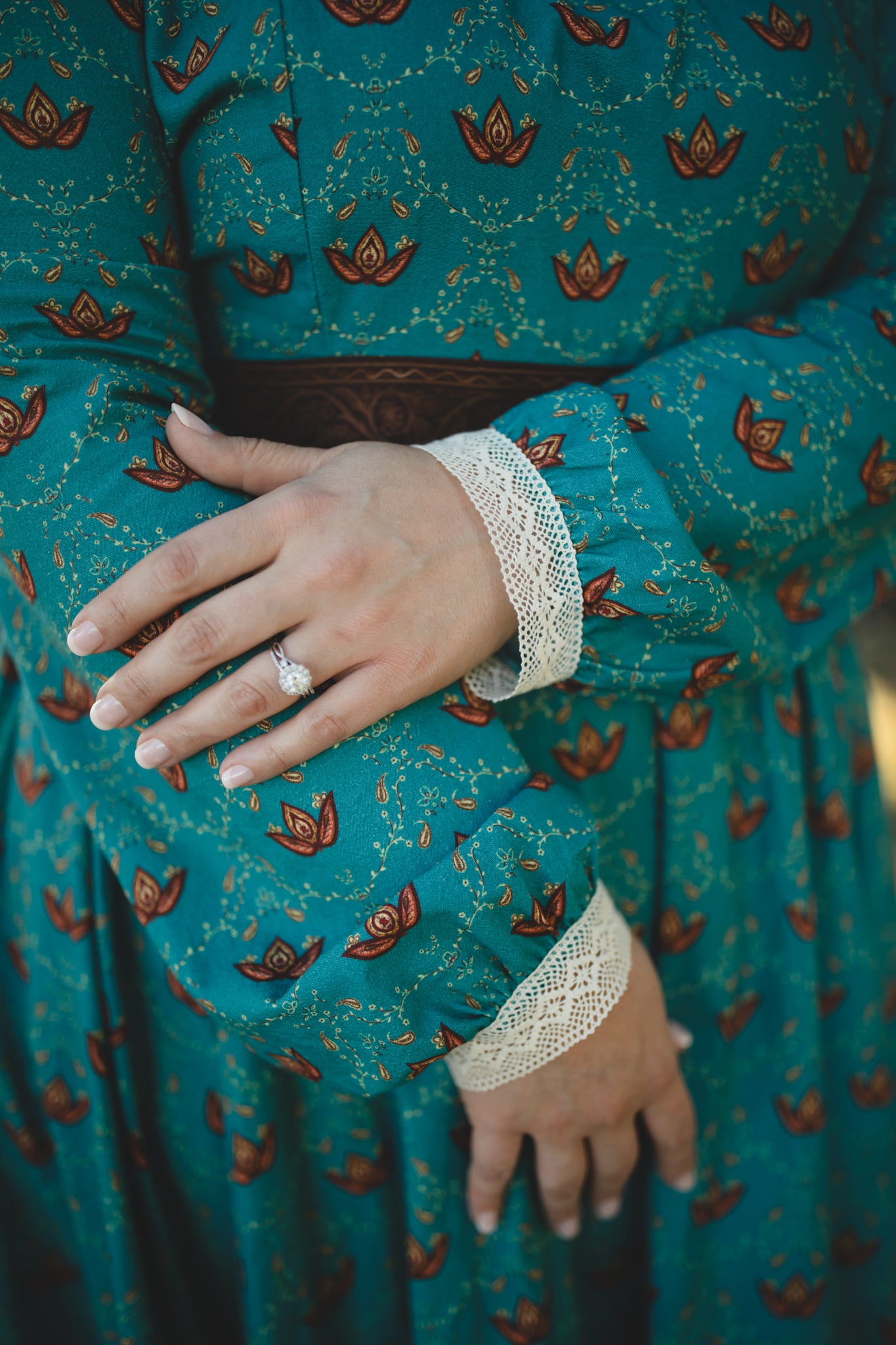 Woman in modest nursing teal dress with floral pattern