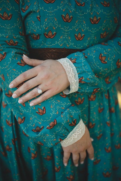 Woman in modest nursing teal dress with floral pattern