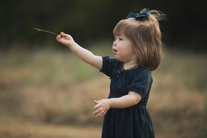 Girl in modest dress playing outdoors