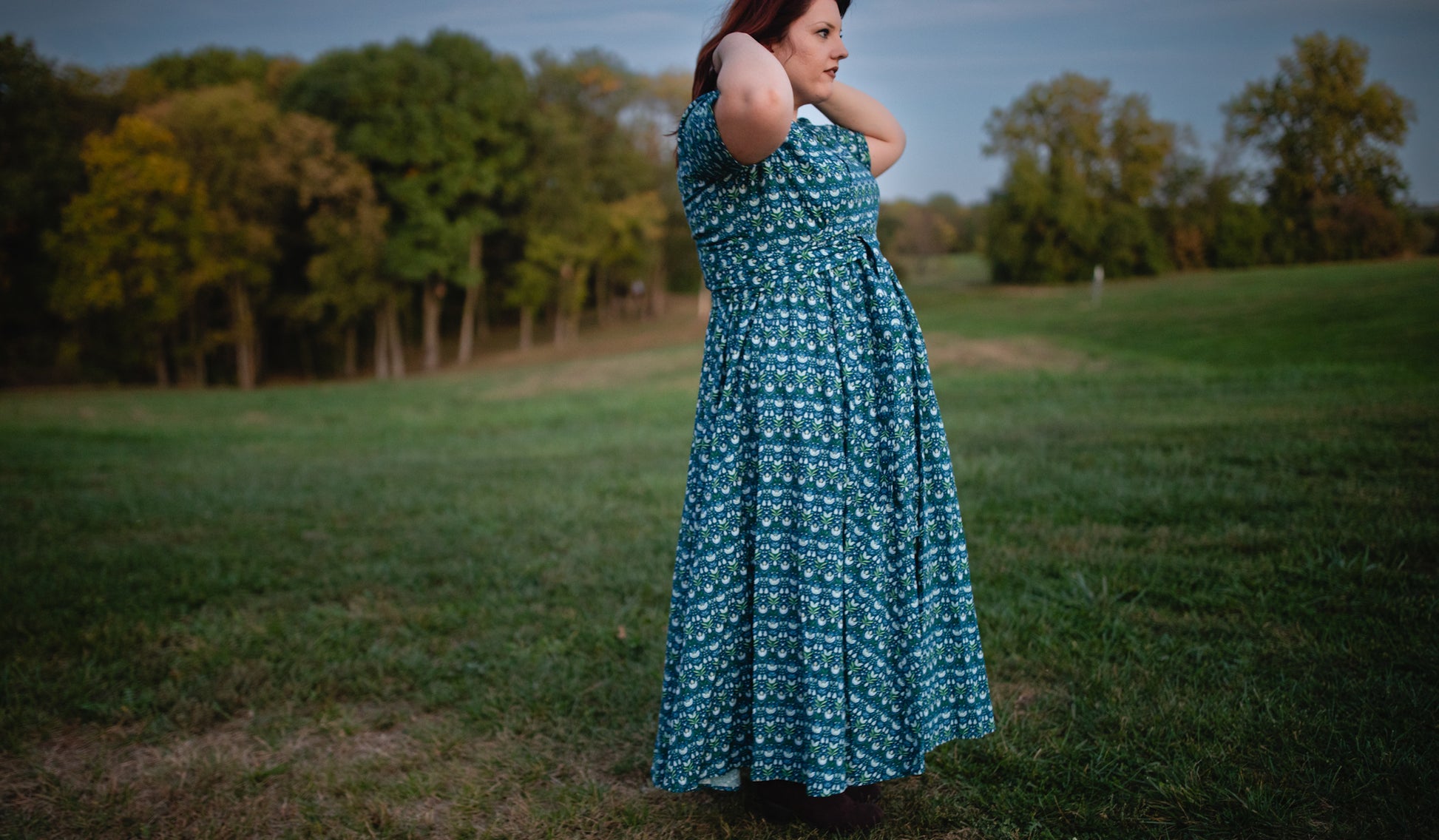 Woman in modest nursing dress in field