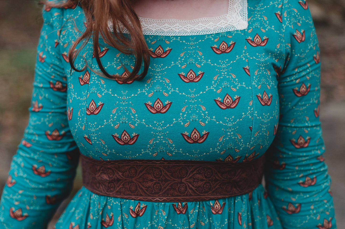 Woman in modest nursing teal dress with belt